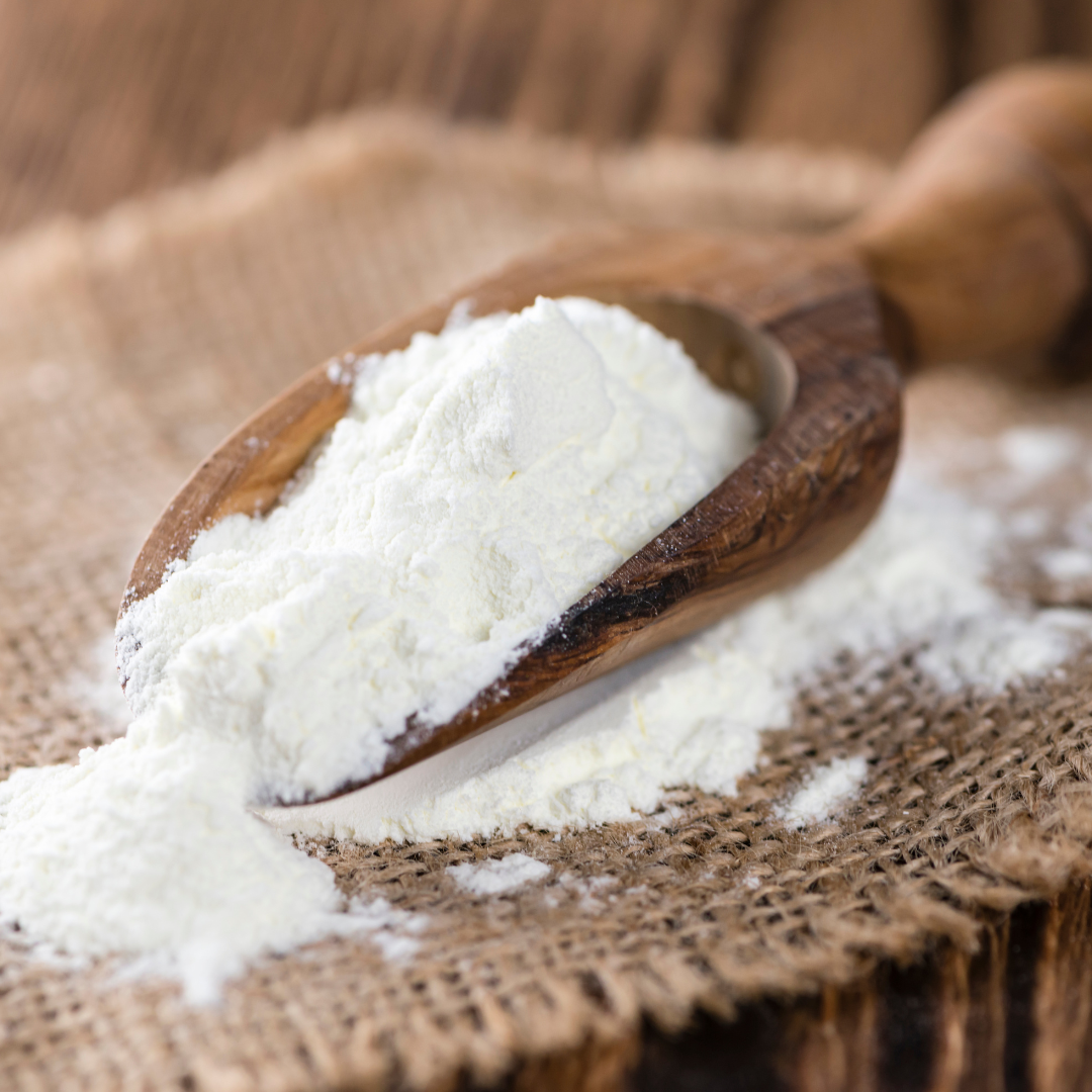 A scoop of 100% natural handcrafted Organic Vegan Bath Milk which is perfect for eczema and psoriasis made with organic, vegan and cruelty-free ingredients, showcasing its smooth texture.