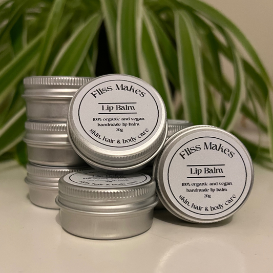 Lip balm tins of 100% natural handcrafted lip balm made with organic, vegan and cruelty-free ingredients, showcasing its smooth texture.