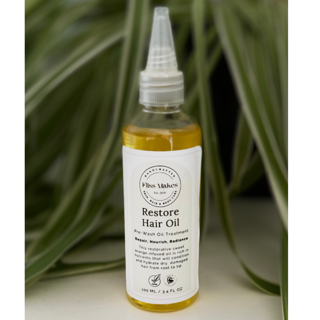 Bottle of 100% natural handcrafted Restore Hair Oil for dry hair made with organic, vegan and cruelty-free ingredients, showcasing its smooth texture.