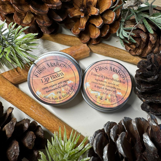 Two tins of 100% natural handcrafted limited edition toasted marshmallow lip balm made with organic, vegan and cruelty-free ingredients, showcasing its smooth texture.